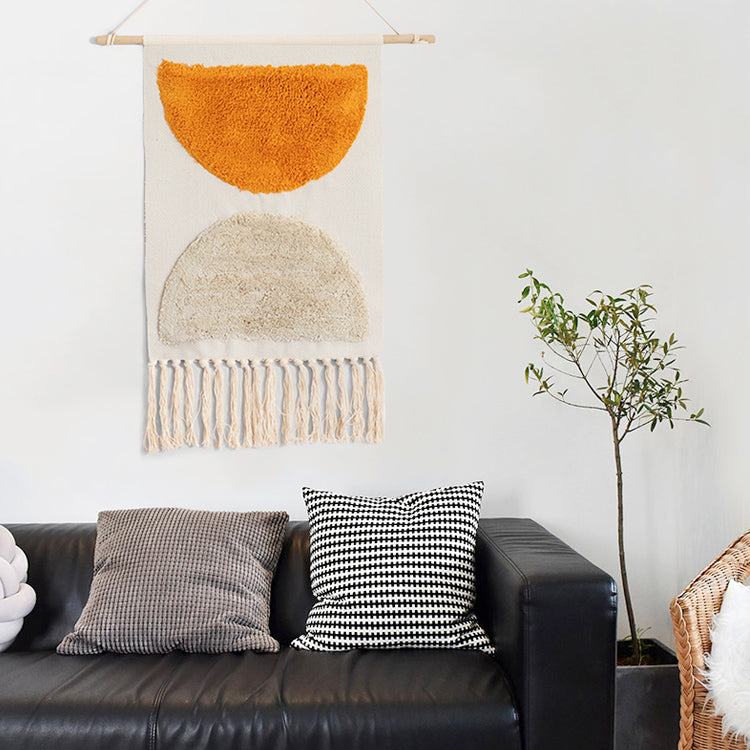 Woven wall hanging above a sofa in a bright living room