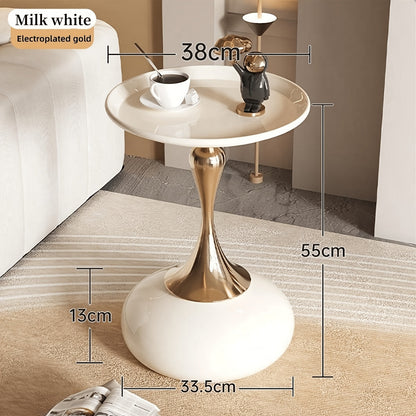 Stylish side table featuring a gold tulip-shaped base | ribuella