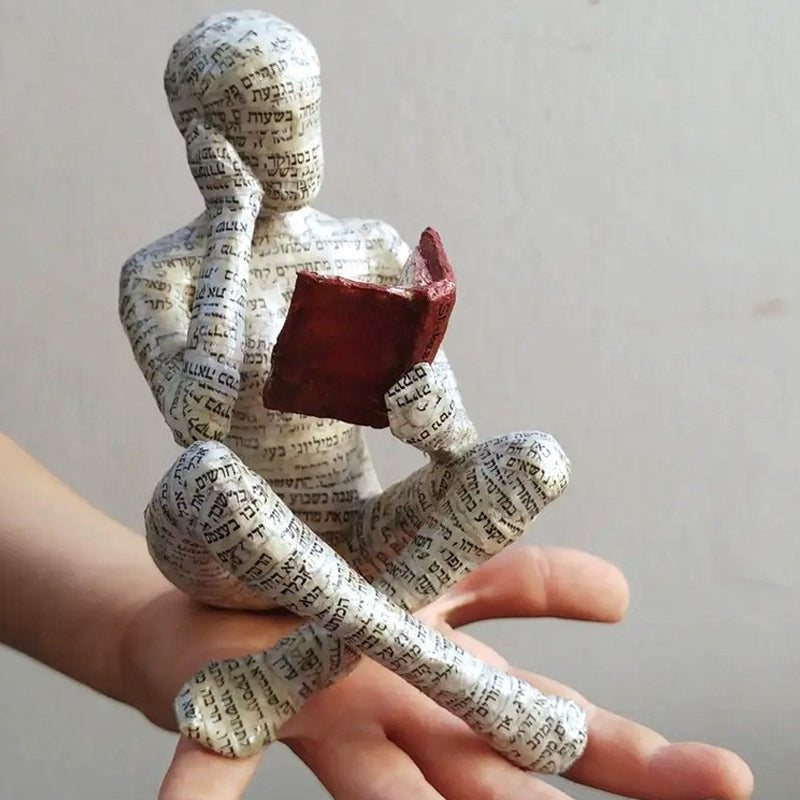 Resin Reading Statue Featuring Newspaper Print Design | ribuella
