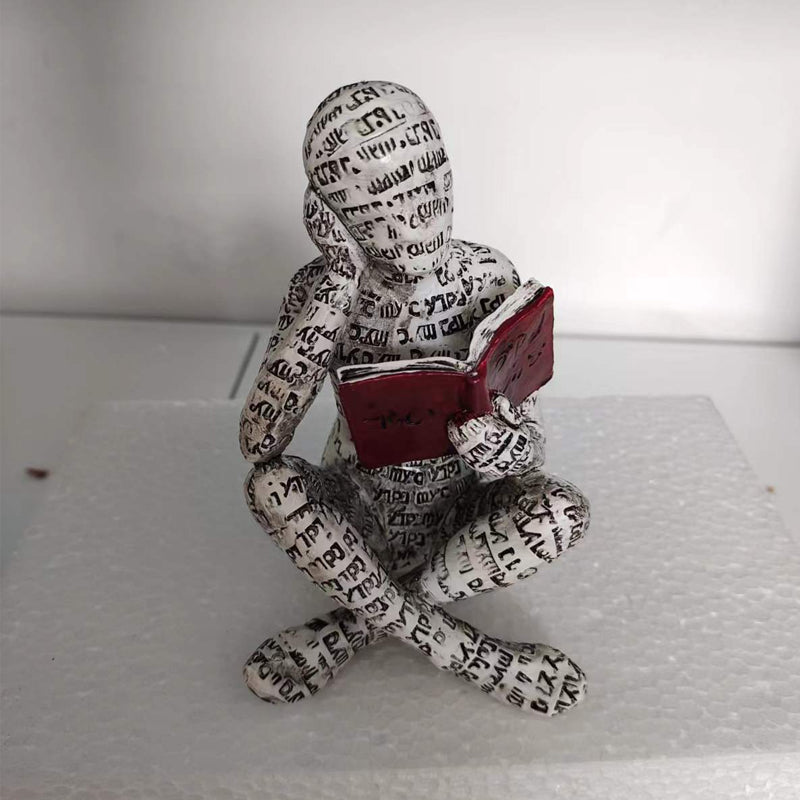 Resin Reading Statue Featuring Newspaper Print Design | ribuella