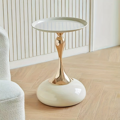 Stylish side table featuring a gold tulip-shaped base | ribuella