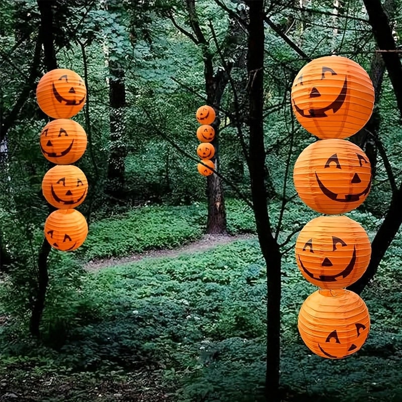 12 papierowych wiszących lampionów w kształcie dyni, z klasycznymi halloweenowymi twarzami Jack-o’-lantern